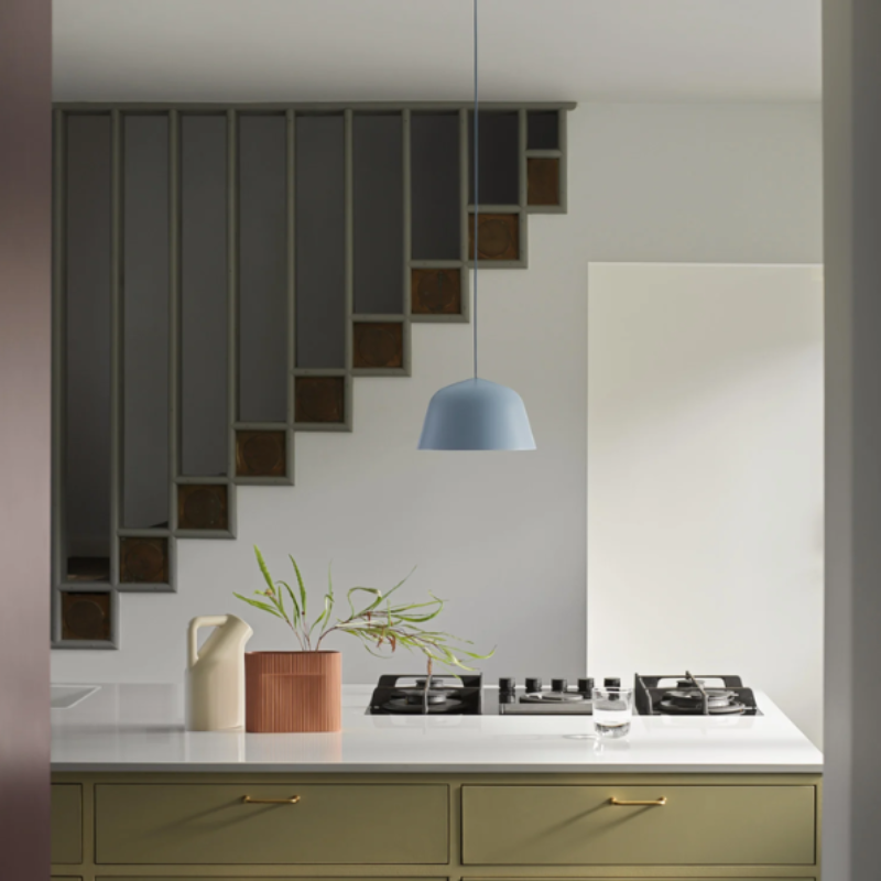 The light blue Ambit Pendant Lamp from Muuto in a kitchen.