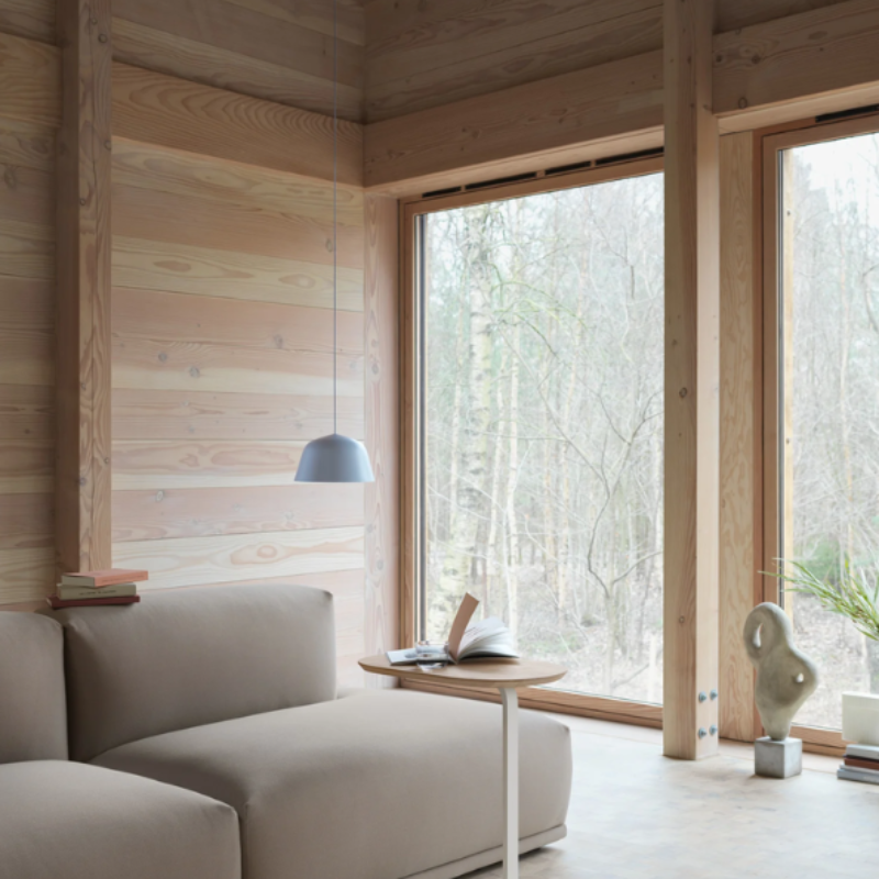 The light blue Ambit Pendant Lamp from Muuto in a living area.