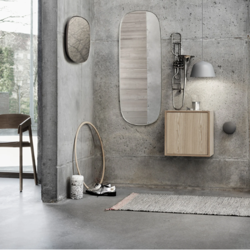 The gray Ambit Pendant Lamp from Muuto in a primary bedroom.