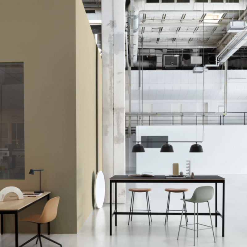 The black Ambit Rail Lamp from Muuto in a commercial office.