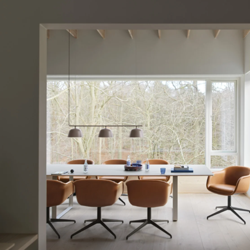 The taupe Ambit Rail Lamp from Muuto in a dining room.