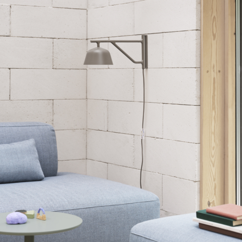 The taupe Ambit Wall Lamp from Muuto in a living room.