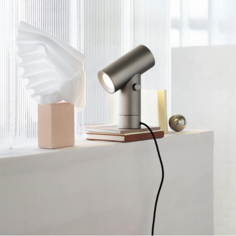 The aluminum Beam Table Lamp from Muuto on a windowsill.