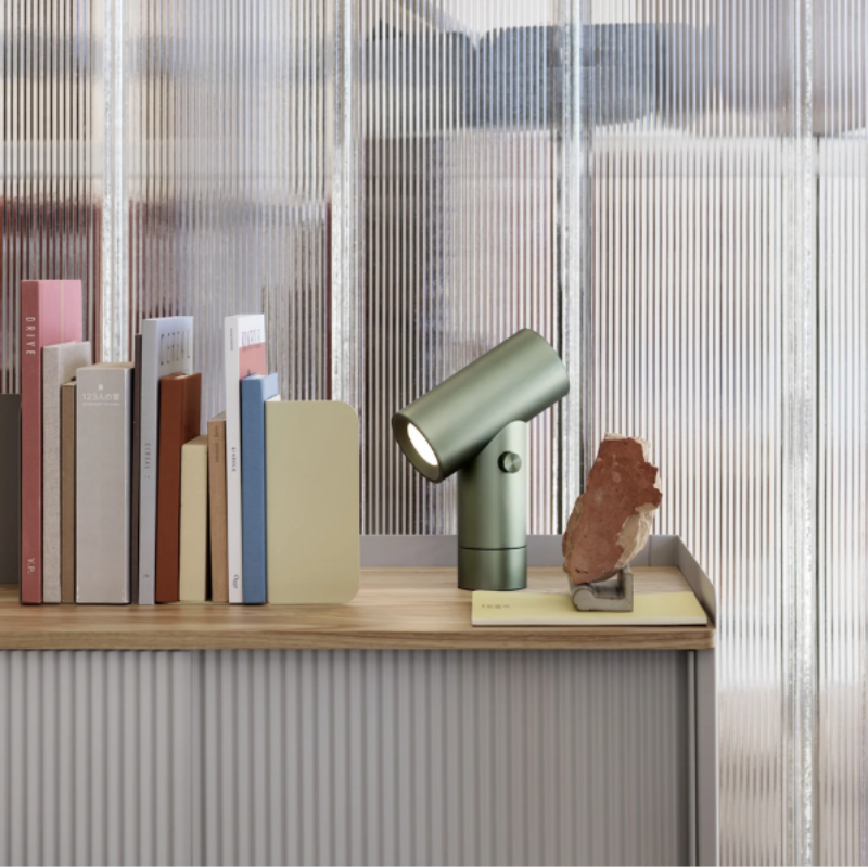 The umber Beam Table Lamp from Muuto on a desktop.