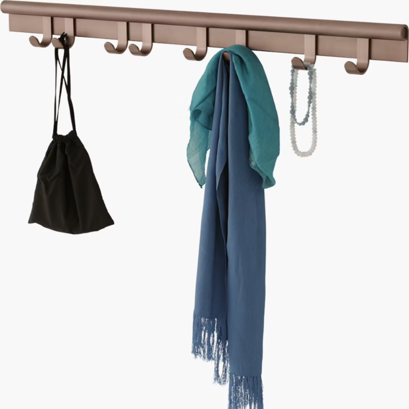 The Coil Coat Rack Large Plum from Muuto with the hanging items.
