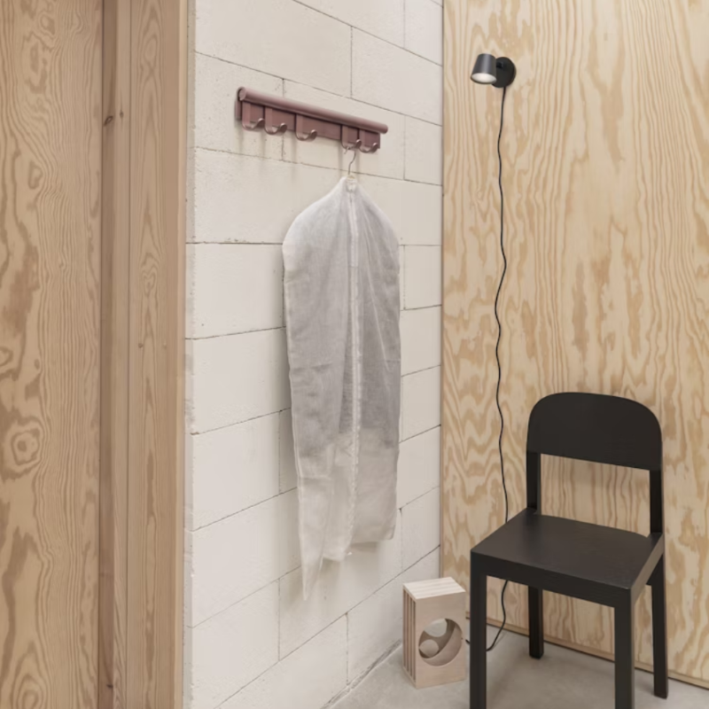 The Coil Coat Rack from Muuto in a living room. all-groups