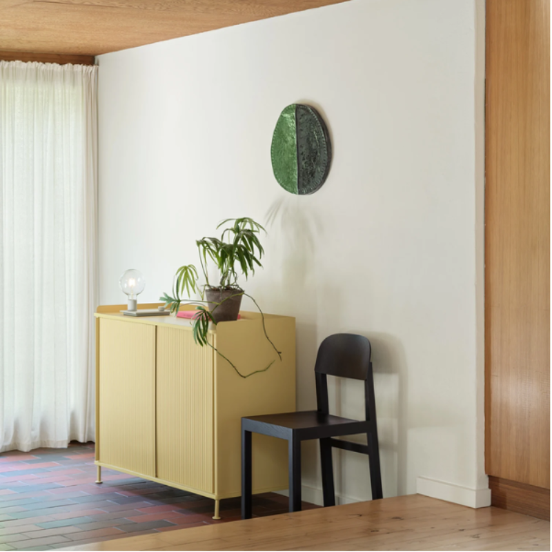 The gray Control Table Lamp from Muuto in a primary bedroom.