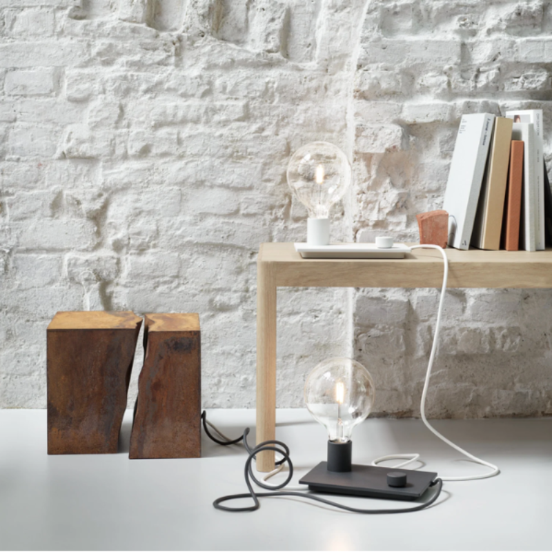 The white Control Table Lamp from Muuto in a lounge.