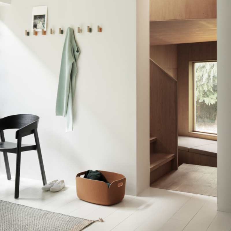 The Cover Armchair from Muuto in black in an entryway.