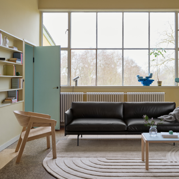 The Cover Lounge Chair from Muuto made with oak in a living room.