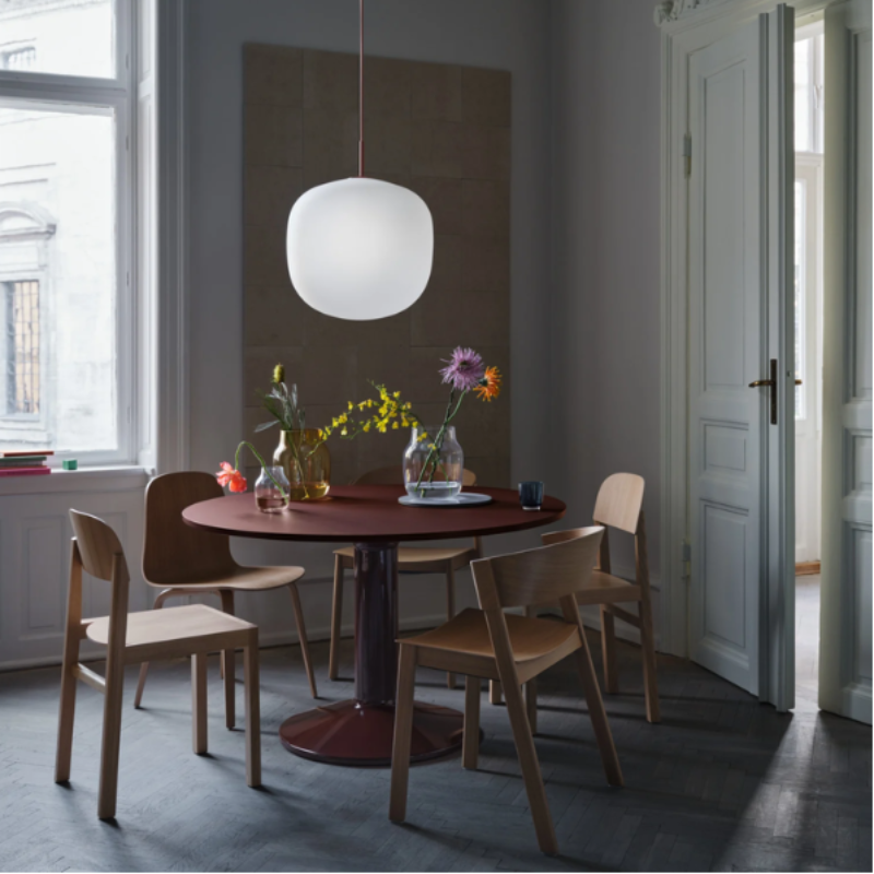 The Cover Side Chair from Muuto in oak in a dining room.