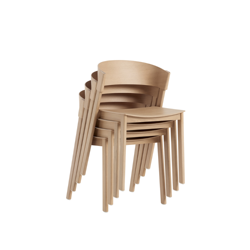 The Cover Side Chair from Muuto in oak stacked.