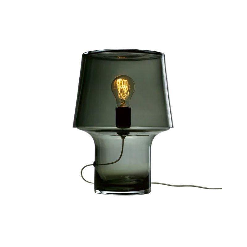 Dark glass table lamp with a visible light bulb.
