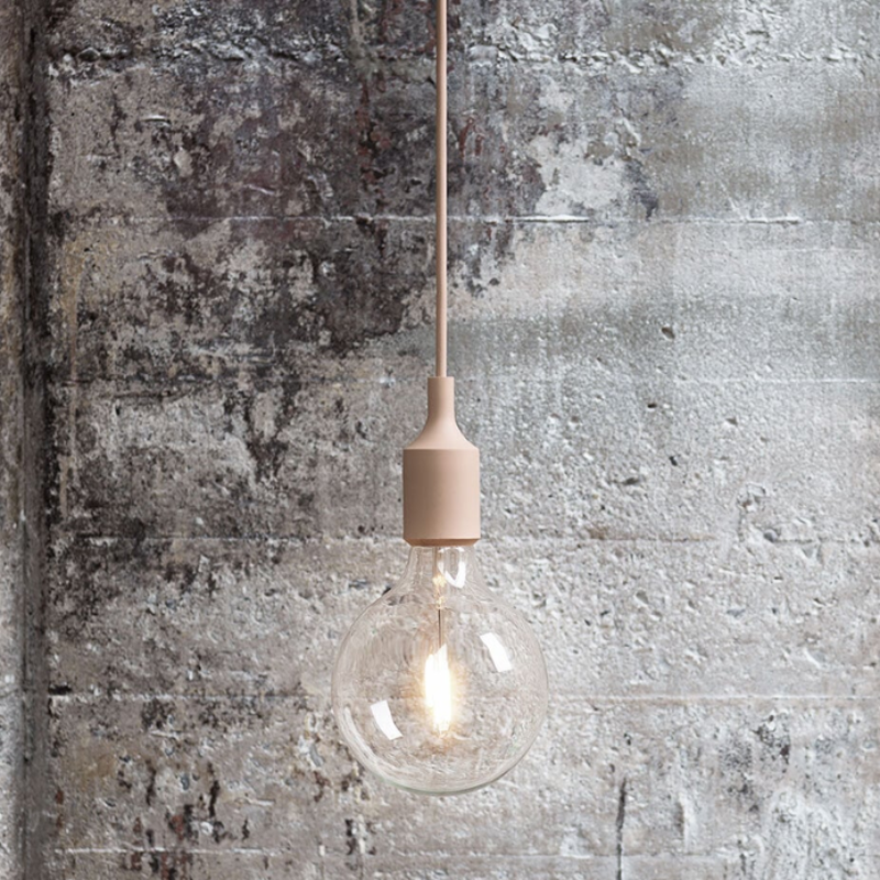 The beige rose E27 Pendant Lamp from Muuto in a living room.