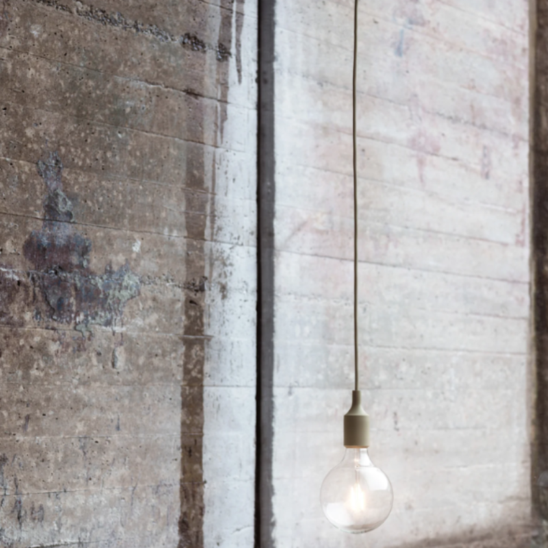 The olive E27 Pendant Lamp from Muuto in a living space.