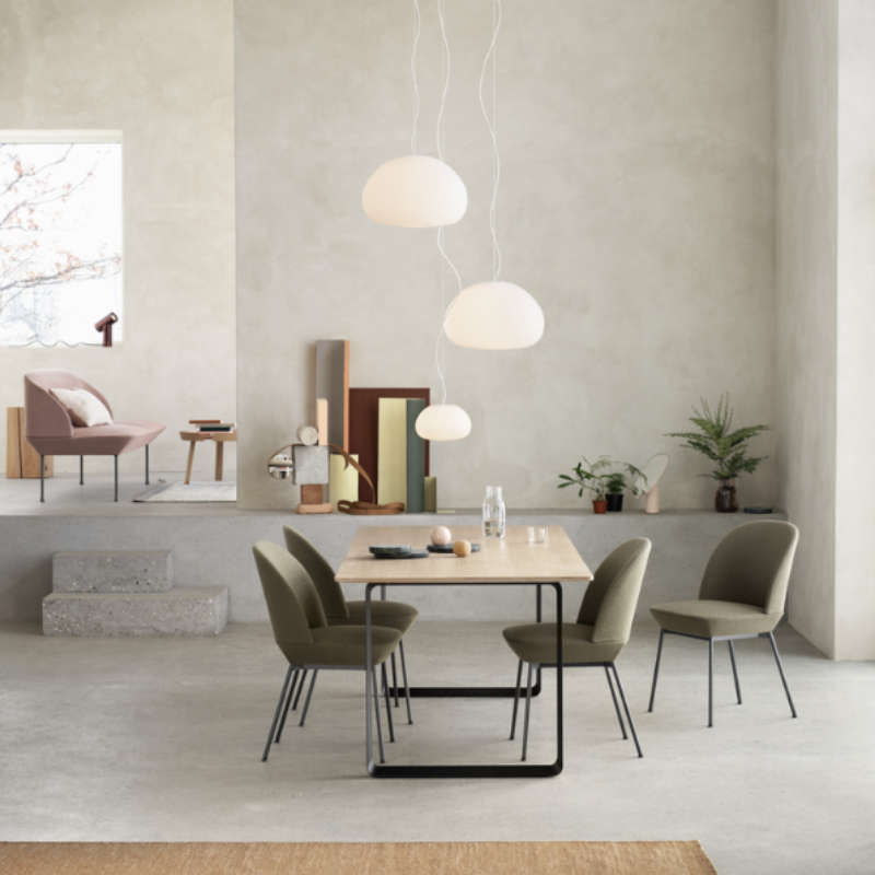Two large Fluid Pendant Lamps from Muuto in a dining room.