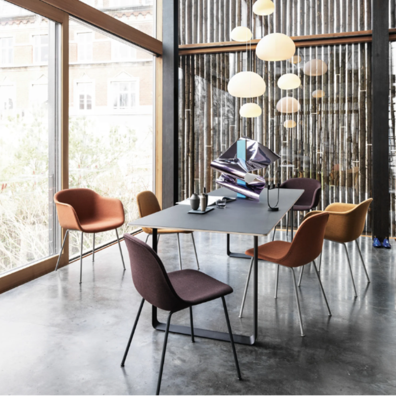 Multiple large Fluid Pendant Lamps from Muuto in a meeting room.