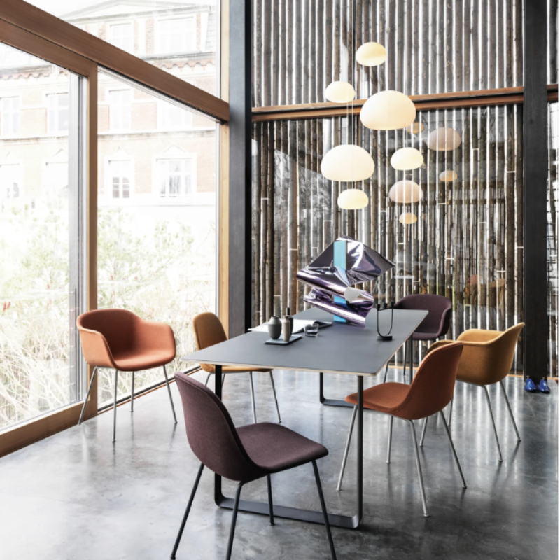 Multiple small Fluid Pendant Lamps from Muuto in a conference room.