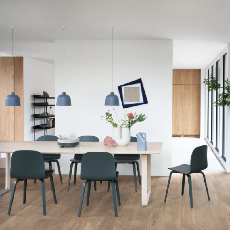 The blue gray Grain Pendant Lamp from Muuto in a dining room.