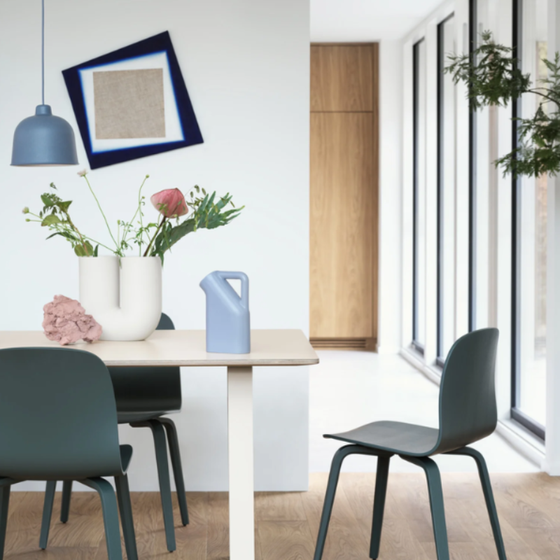 The blue gray Grain Pendant Lamp from Muuto in a dining space.