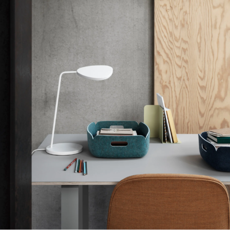 The white Leaf Table Lamp from Muuto in a workspace.