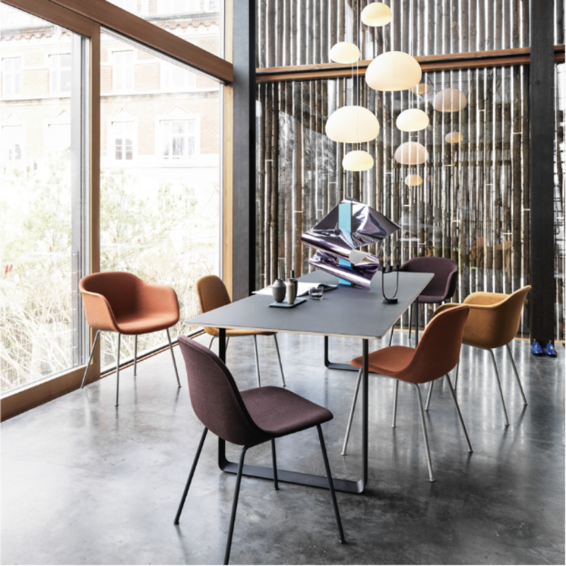 The Leather Fiber Chair from Muuto with cognac refined leather and an anthracite black metal base in a dining room.