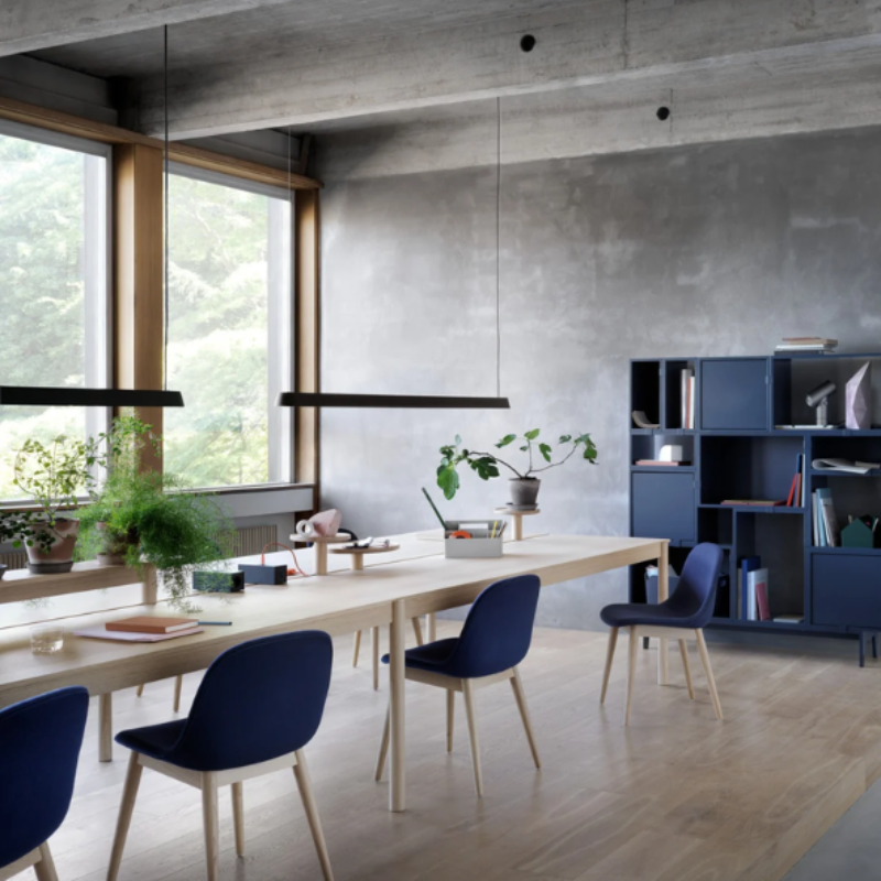 The black Linear Pendant Lamp from Muuto in a living room.