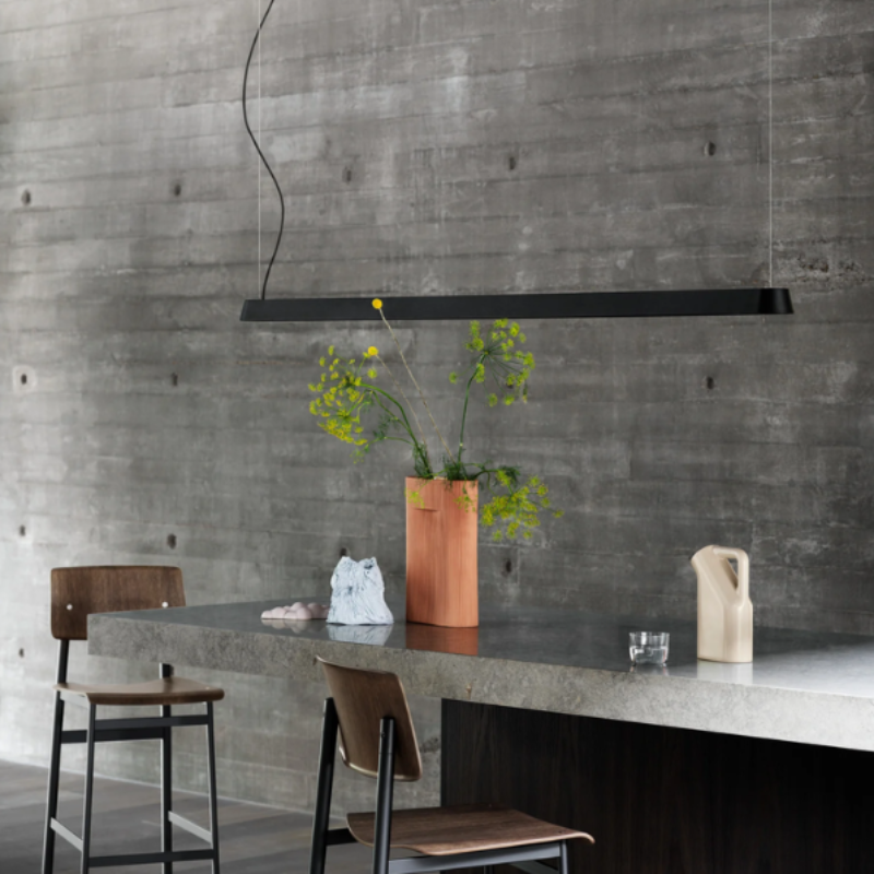 The black Linear Pendant Lamp from Muuto in a meeting room.