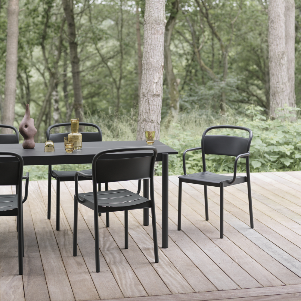 The black Linear Steel Table from Muuto in an outdoor dining space.