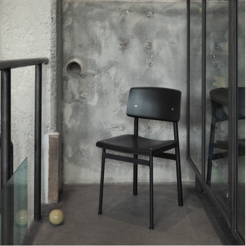 The Loft Chair from Muuto in black and black on a terrace.