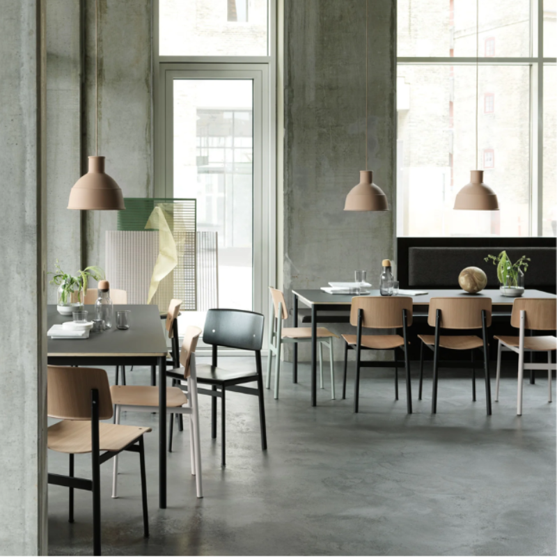 The Loft Chair from Muuto in a variety of colors within a restaurant. all-groups