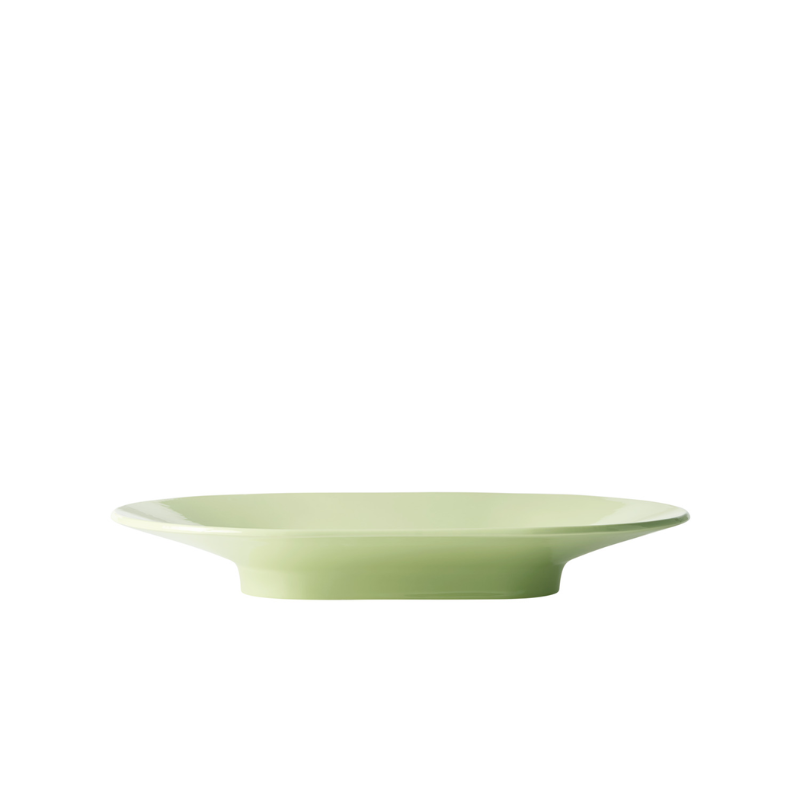 The wide Mere Bowl from Muuto in light green from the side.