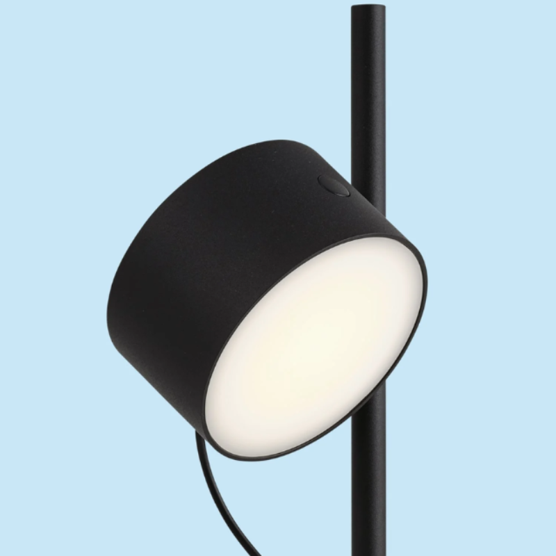 The black Post Table Lamp from Muuto in a studio.
