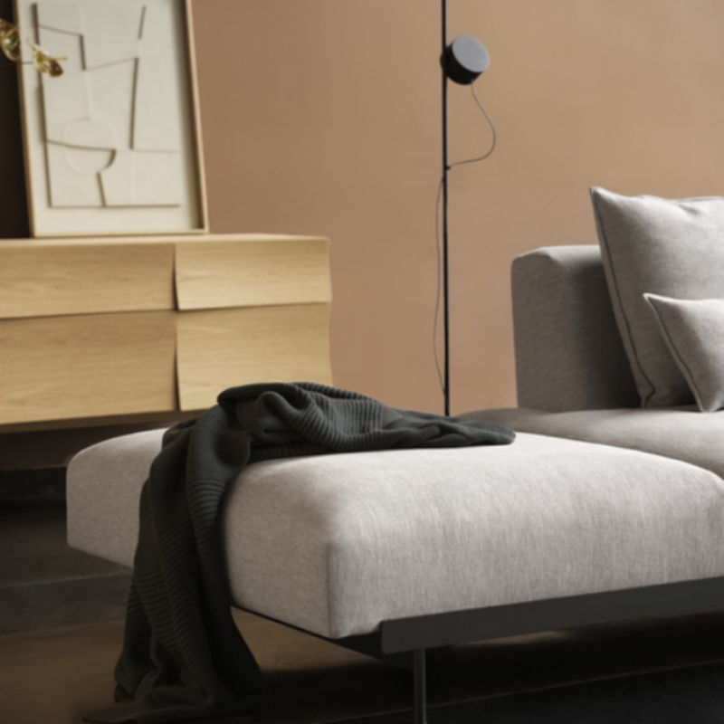 The oiled oak Reflect Sideboard from Muuto in a primary bedroom.