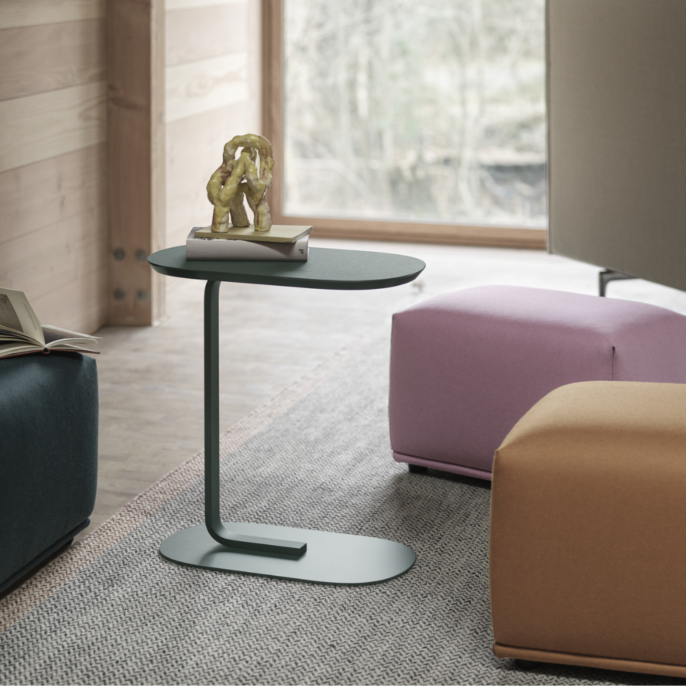 The dark green Relate Side Table from Muuto in a family area.