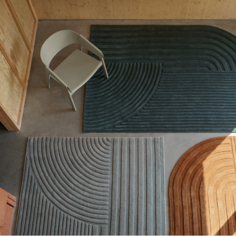 The Relevo Rug from Muuto, an asymmetrical area rug in a studio space. all-groups