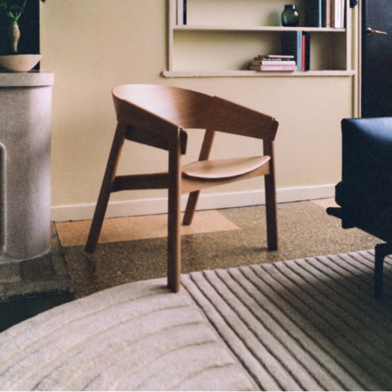 The Relevo Rug from Muuto in off white in a bedroom.