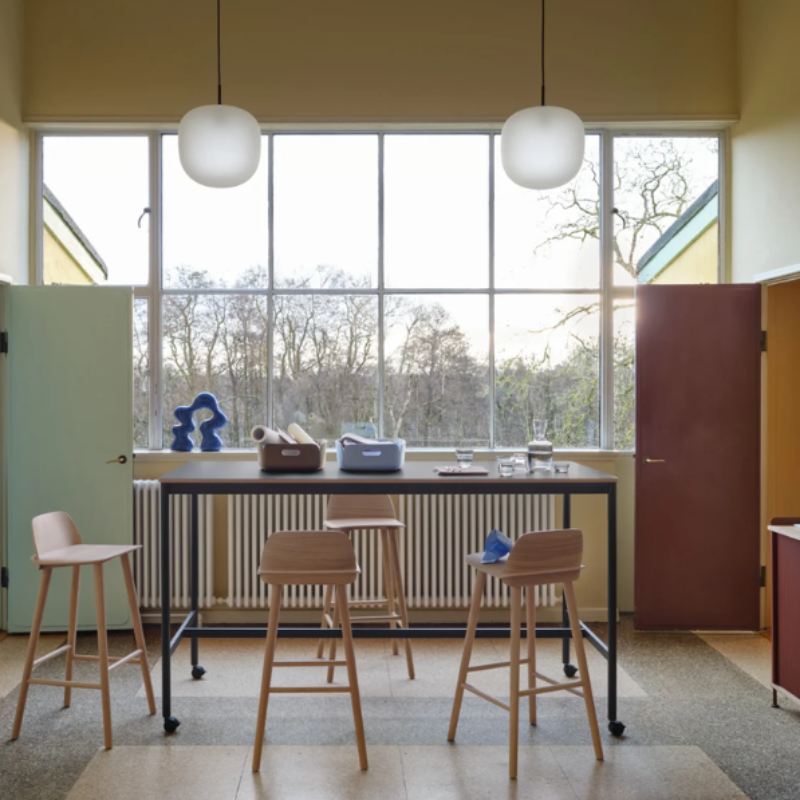 Two black Rime Pendant Lamps from Muuto in a living room.