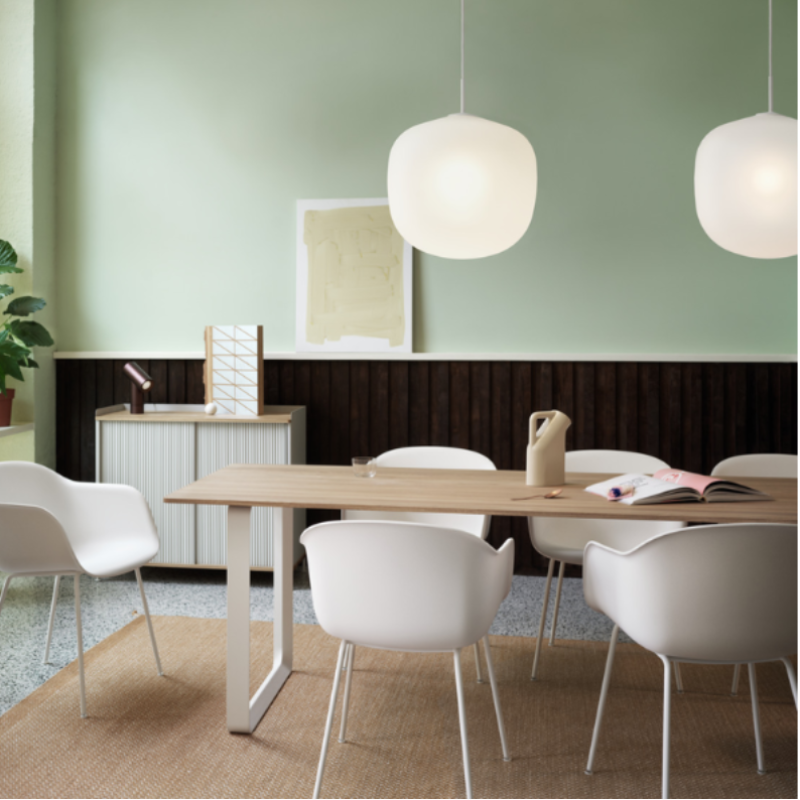 Two white Rime Pendant Lamps from Muuto in a living space.