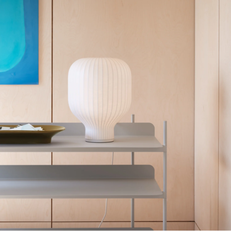 The Strand Table Lamp from Muuto in a living room.