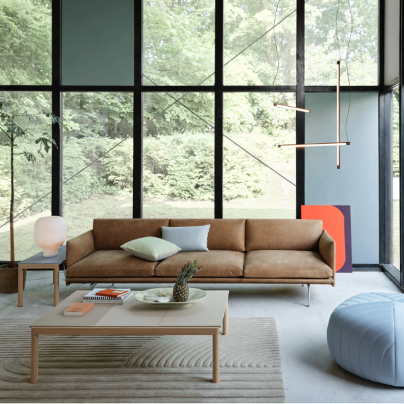 The Strand Table Lamp from Muuto in a lounge lifestyle photograph.