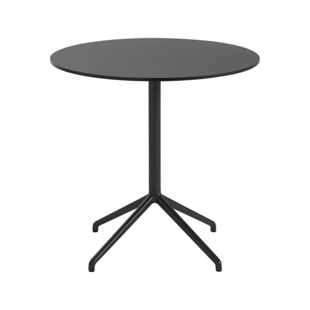 The 29 inch Still Round Cafe Table from Muuto with the black nanolaminate table top and black frame.