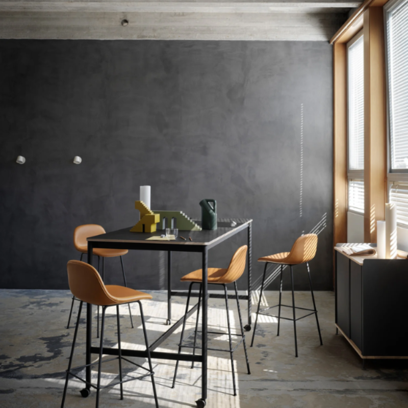 The Tip Wall Lamp from Muuto in white within a living room.