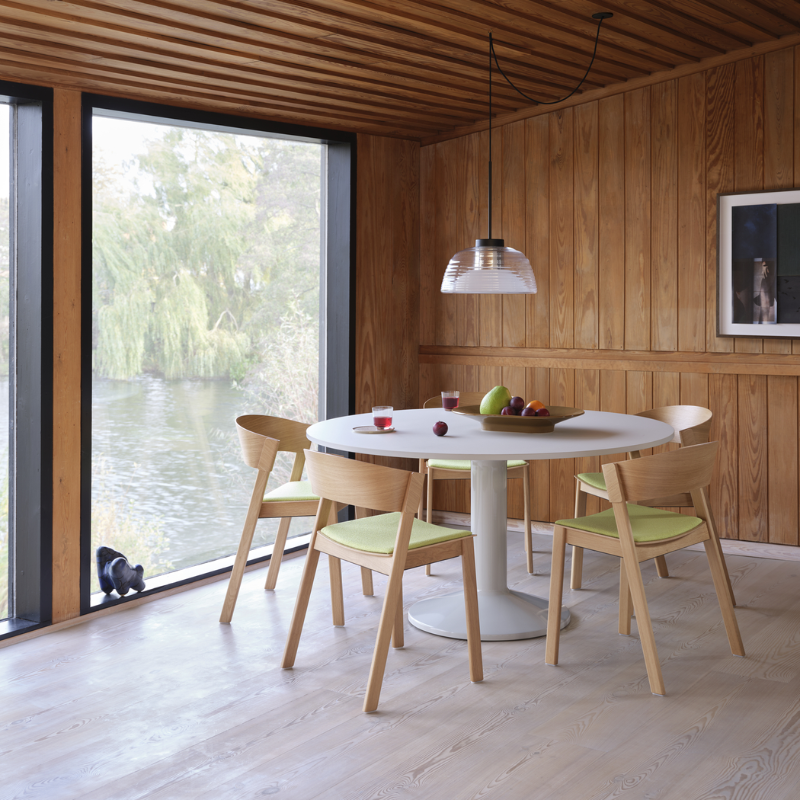 The Two Layer Pendant Lamp Black from Muuto in a dining room.