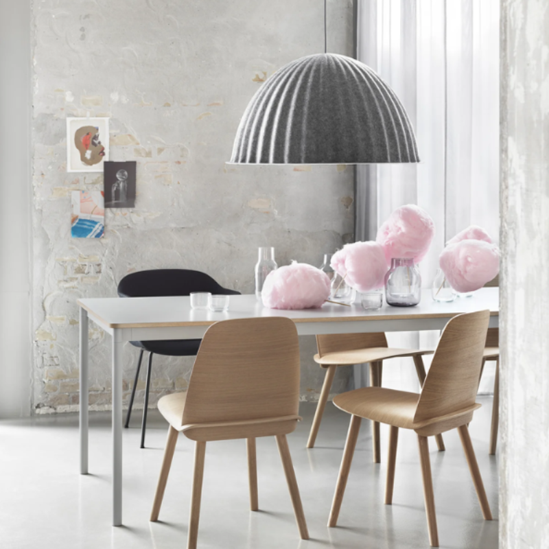 The gray Under the Bell Pendant Lamp from Muuto in a family space.