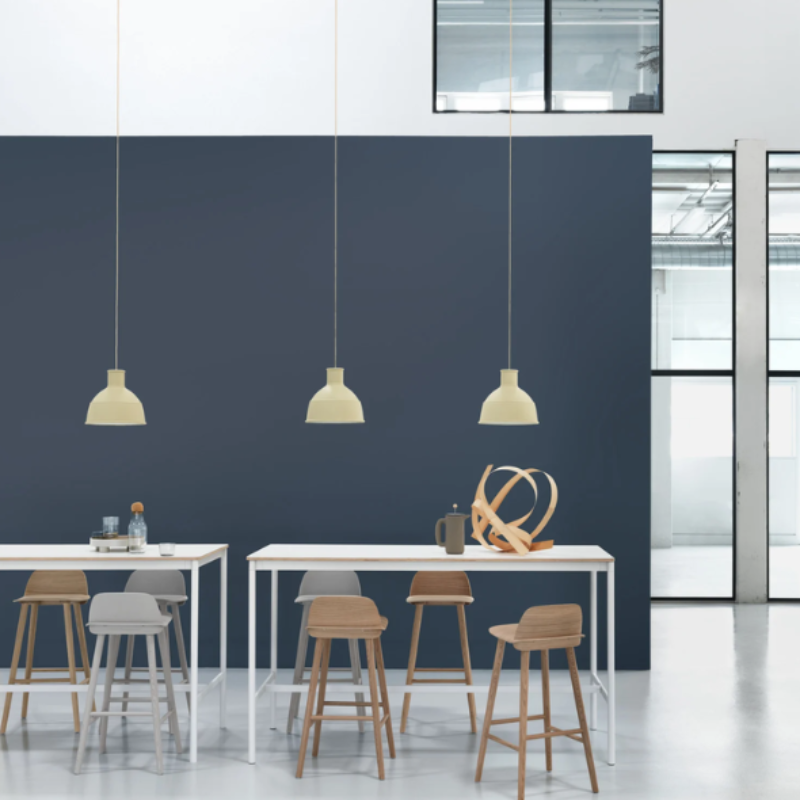 The beige green Unfold Pendant Lamp from Muuto in a commercial space.
