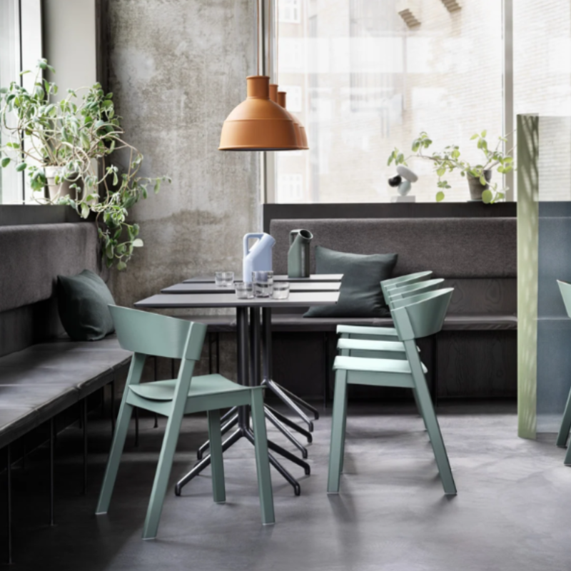 The terracotta Unfold Pendant Lamp from Muuto in a dining area.
