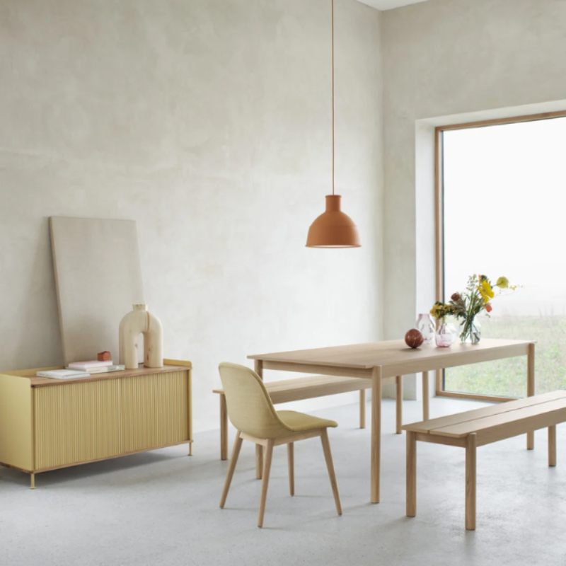 The terracotta Unfold Pendant Lamp from Muuto in a living room.