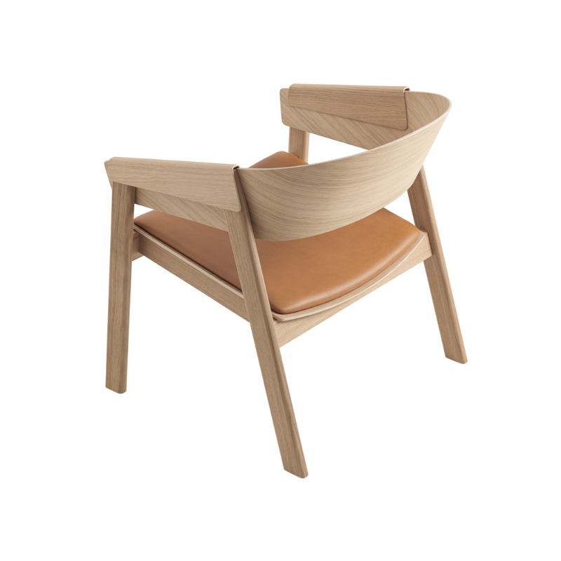 The Upholstered Cover Lounge Chair from Muuto with cognac refine leather in oak from the back.