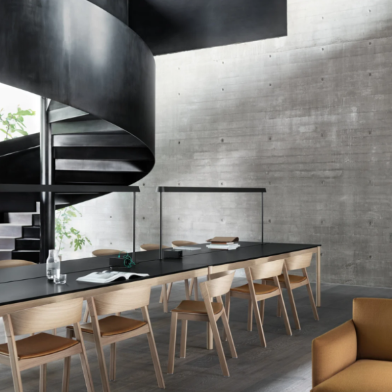 The Upholstered Cover Side Chair by Muuto with cognac refine leather in oak in a lounge.